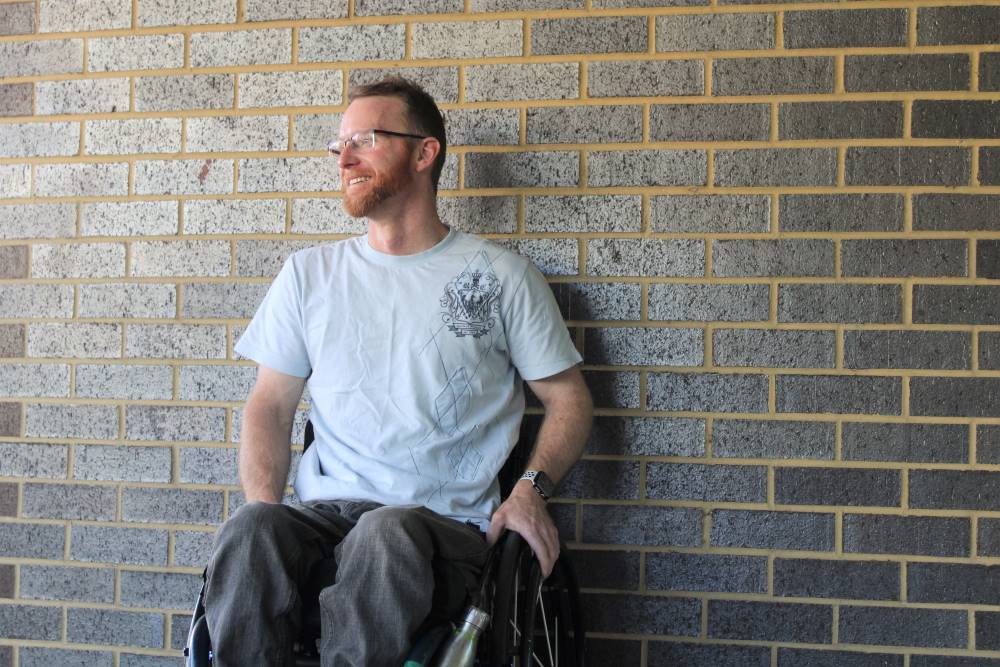 male wheelchair user smiles