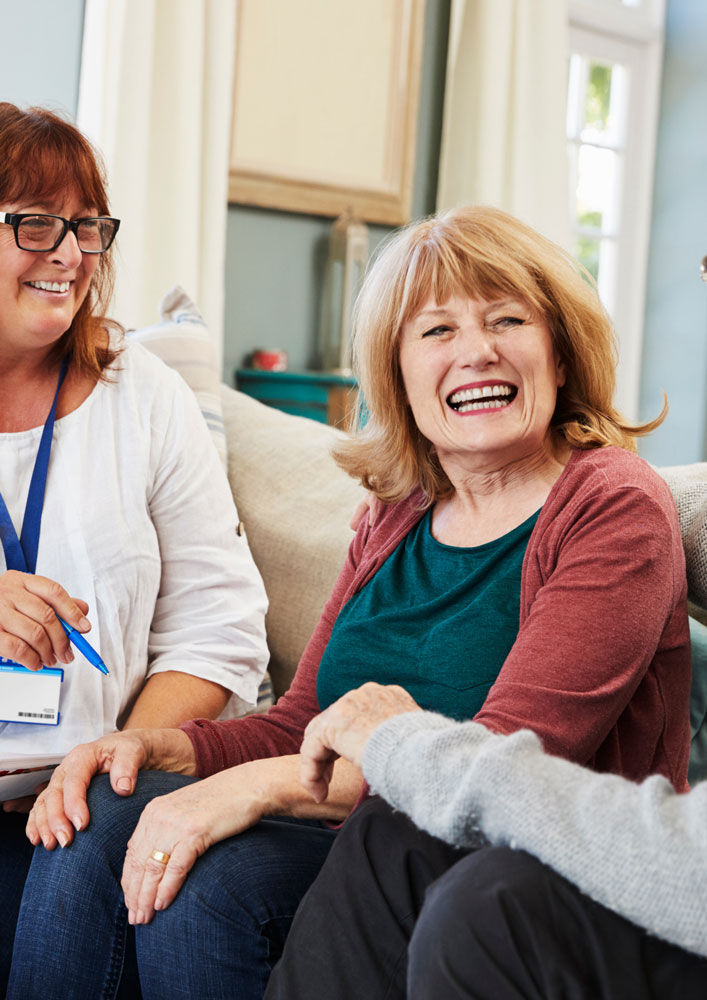 Assessor and clients chatting on a couch