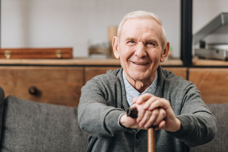 Older-man-sat-with-walking-stick